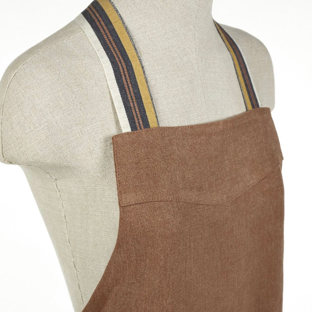 libeco apron in a red earth tone on a mannequin 