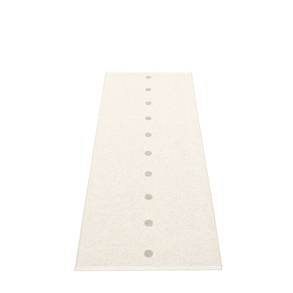 white rug with grey small dots on a white floor