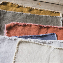 Load image into Gallery viewer, different colored libeco placemats all on top of one another
