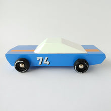 Load image into Gallery viewer, A photo of the side of a blue stockcar with white top, black wheels, and number 74 on the door. 
