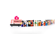 Load image into Gallery viewer, wooden donut truck from candylab on a white background with a line of lego people waiting to get a donut

