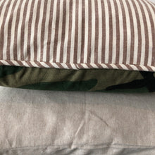 Load image into Gallery viewer, close up of the back of the camo pillow (that&#39;s striped) stacked on top of the cream pillow 
