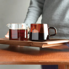 Load image into Gallery viewer, male model holding the kinto walnut tray with two coffees on it
