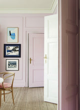 Load image into Gallery viewer, Picture of the inside of a room with 2 open doors on the right side, a closed door in the distance, with 3 paintings hanging beside the door with a chair in front of the pictures. 
