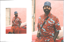 Load image into Gallery viewer, Pae of the book with a black man in a fashionable red outfit
