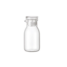 Load image into Gallery viewer, small glass kinto dressing bottle on a white background
